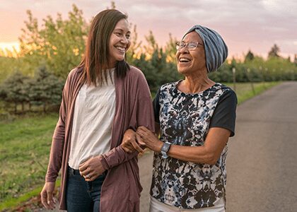 women walking at sunset